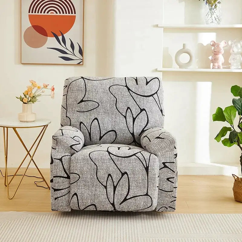 Elastic recliner sofa cover by Simples Market on a gray leaf-pattern armchair in a bright living room.