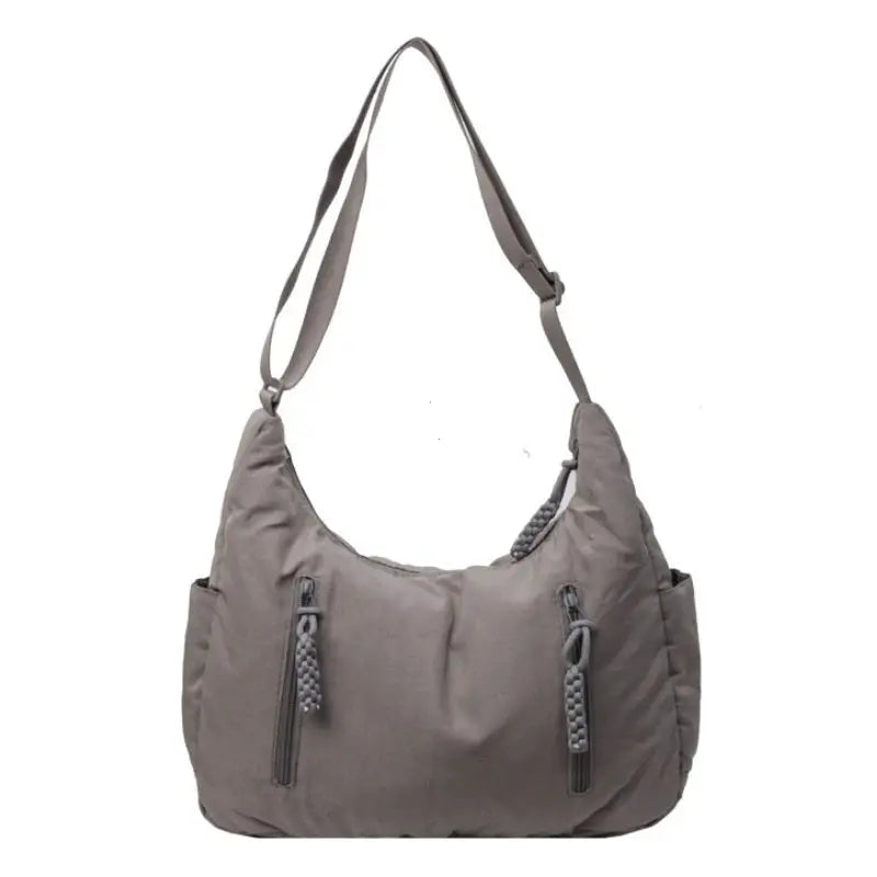 Trendy women's soft cloth shoulder bag, gray with dual front zip pockets featuring rope pulls and adjustable strap