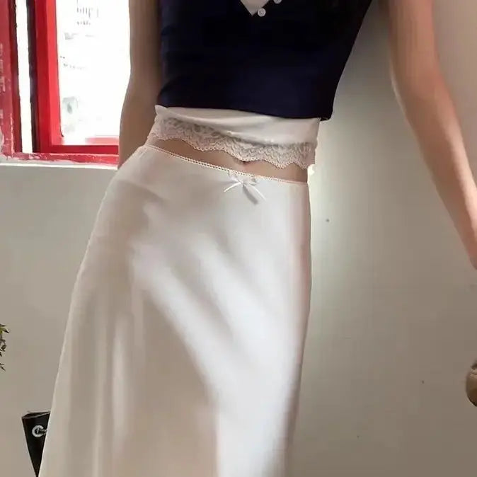 White satin A-line skirt with lace-trimmed waist and small bow detail