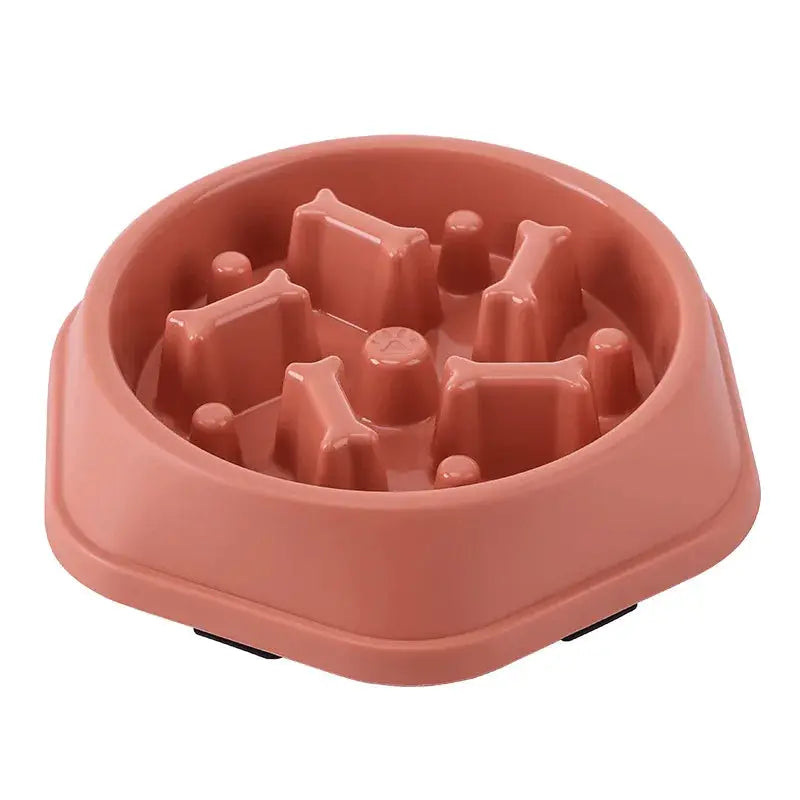 Pink pet slow-feeding bowl for cats and dogs with non-slip base and interior pegs to slow eating.