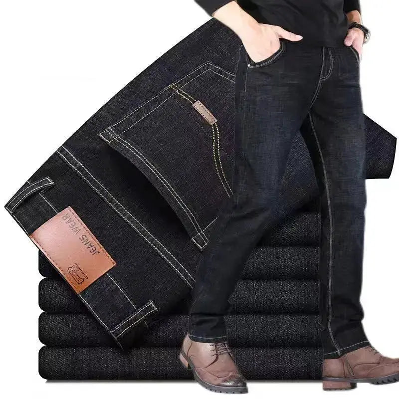 Men's dark denim jeans with leather patch and contrast stitching, slim straight fit.