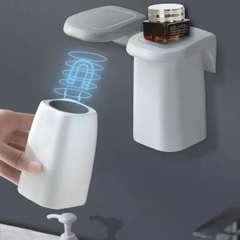 2-piece white magnetic mouthwash cup and wall-mounted toothbrush rack; Estée Lauder jar on top.