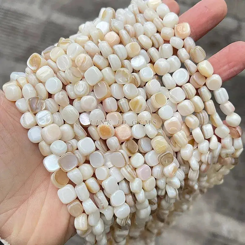 Natural shell beads, irregular square-rounded shapes in white to beige tones for jewelry making