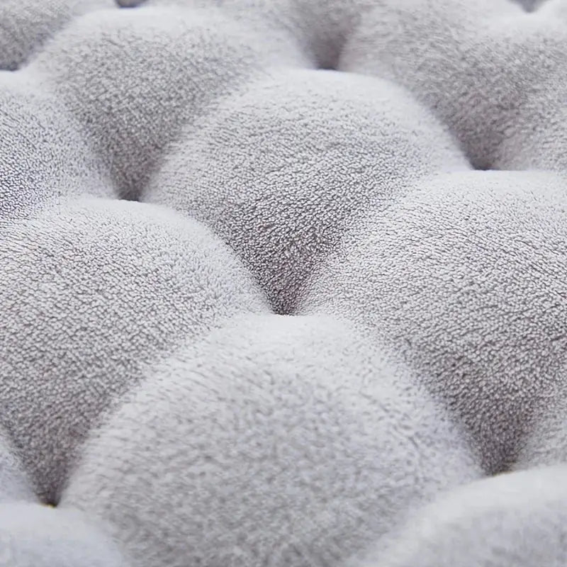 Large biscuit-shaped plush cushion in soft gray fabric