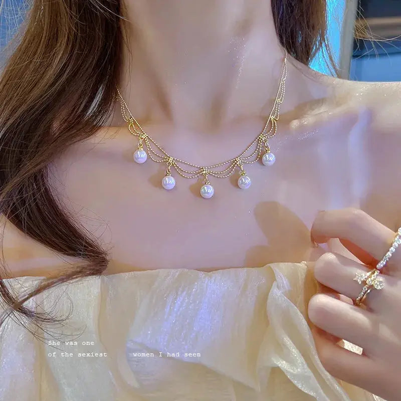 Gold-tone Kpop pearl choker necklace with layered chains and dangling pearls