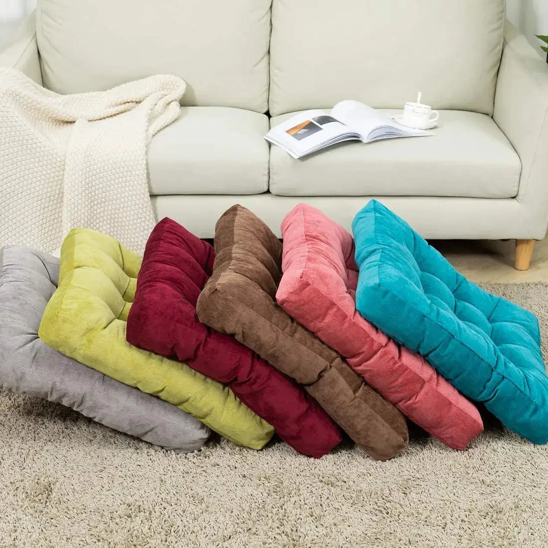 Floor pillow set, 7-piece square tufted cushions in multicolor tones.