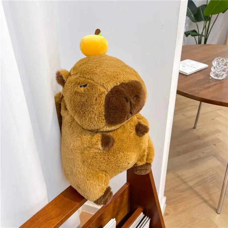 Simples Market plush capybara backpack, brown fuzzy crossbody bag with orange fruit topper