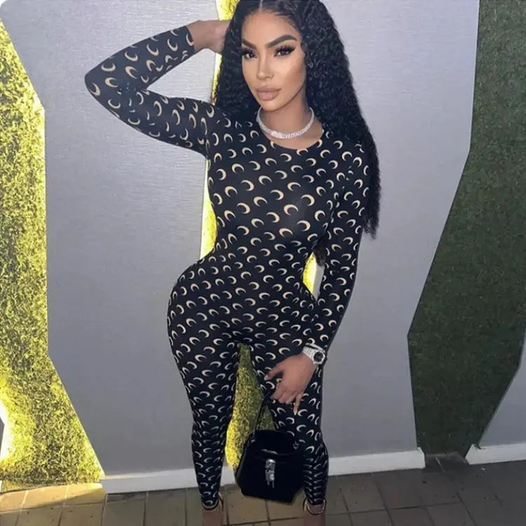 Womens black moon-print jumpsuit with beige crescents, long sleeves, round neck, slim-fit leggings-style