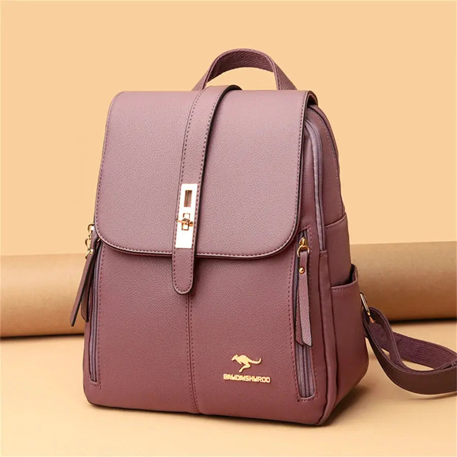 Leather backpack in mauve purple with top handle, front flap strap and gold-tone logo hardware