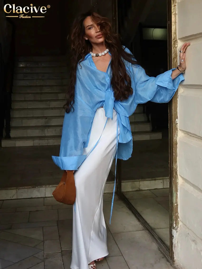 Clacive blue loose blouse with tie-front and long sleeves, styled with white wide-leg pants