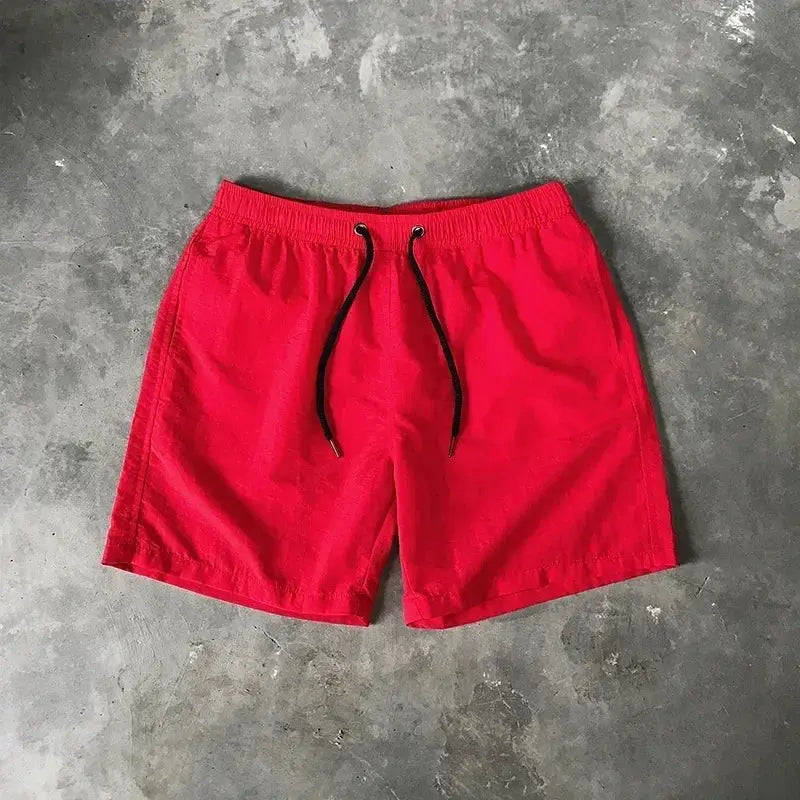 Men's red swim shorts with black drawstring and elastic waistband.