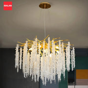 Crystal chandelier with gold-tone branches and clear crystal drops, IRALAN logo visible