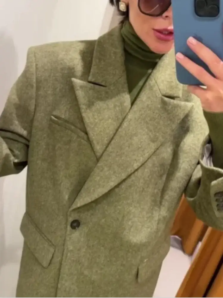 Olive green blazer with soft shoulder pads, wide lapels, textured wool-blend fabric