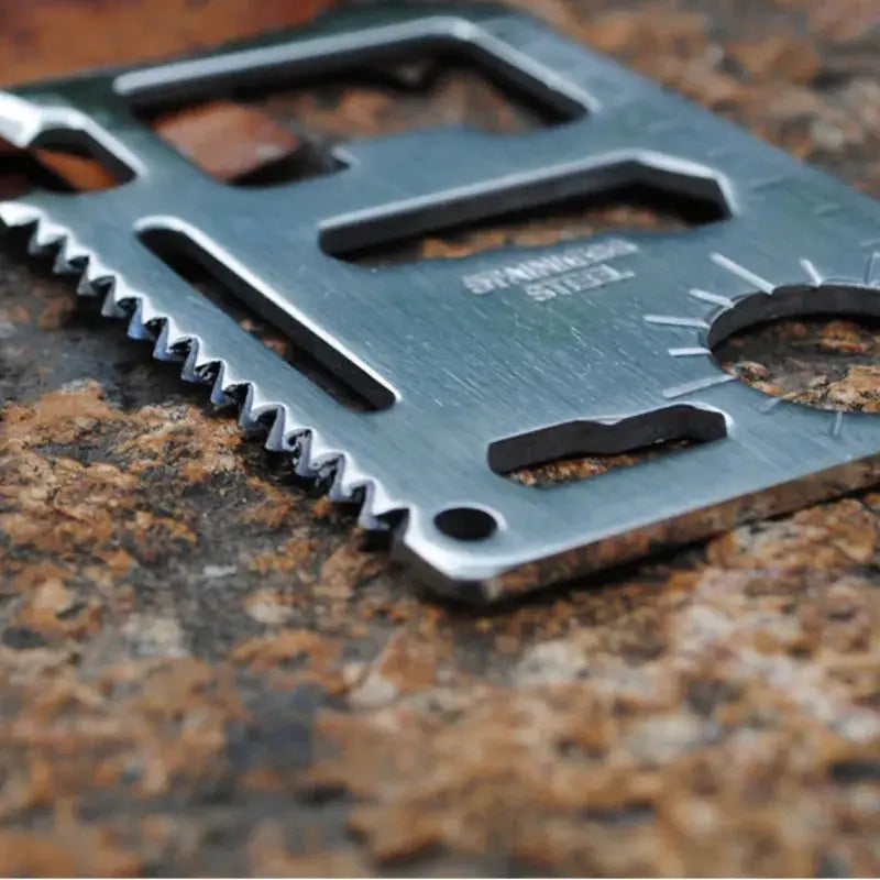 Wallet card knife EDC multi-tool in stainless steel with serrated edge and cutouts