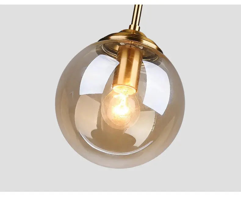 Modern luxury metal chandelier pendant lamp with gold-tone hardware and a clear glass globe
