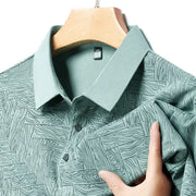 Men's teal patterned polo shirt with short sleeves and geometric print