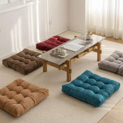 Simples Market floor pillows set of 5 thick tufted square cushions in teal, brown, tan, burgundy, and gray.