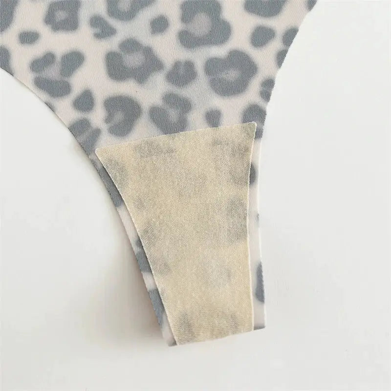 Thong underwear, seamless leopard-print fabric with beige lining, close-up