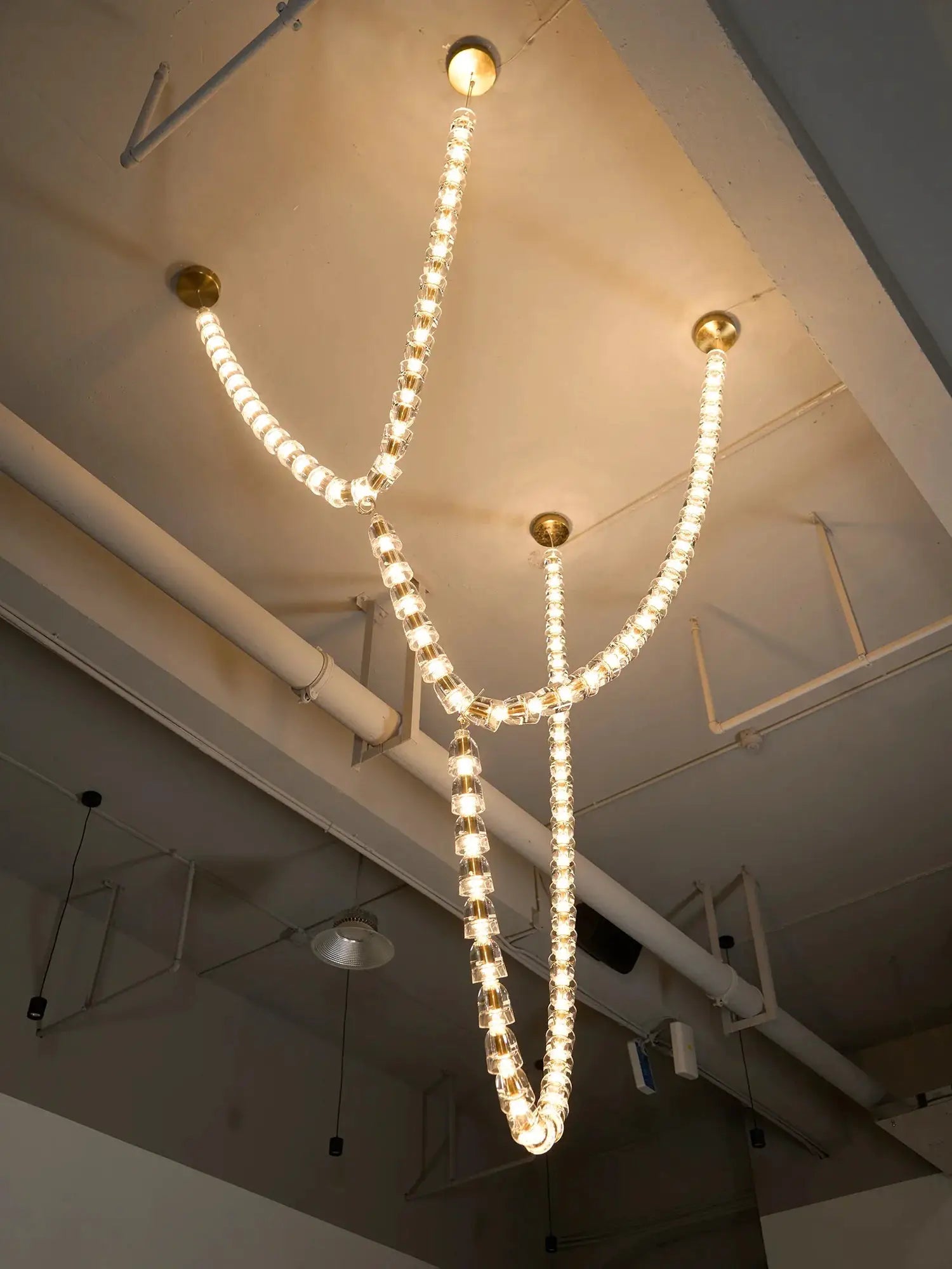 Necklace chandelier with multi-strand clear crystal acrylic beads and gold ceiling mounts; adjustable length.