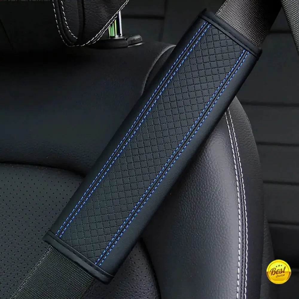 Car seat belt shoulder pad in black PU leather with blue diamond-embossed pattern.