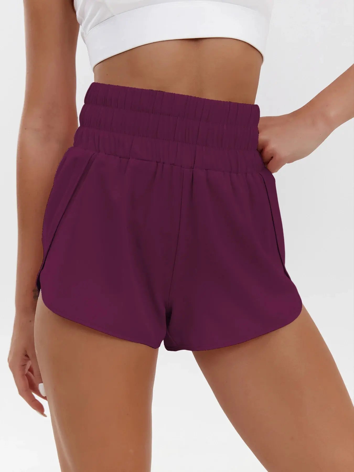 Women's purple high-waist elastic shorts with quick-dry breathable fabric for sporty casual wear.