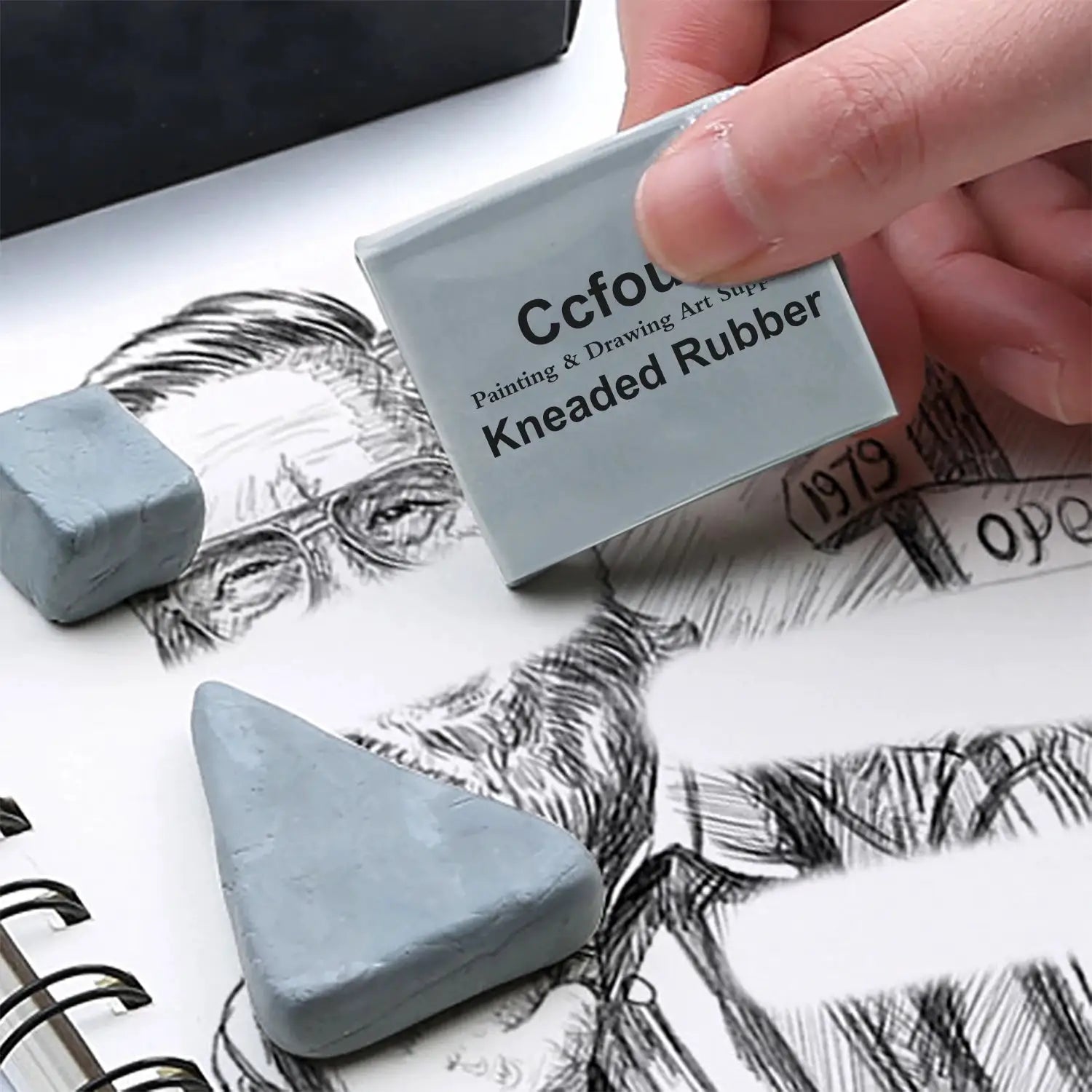 Grey kneaded rubber erasers, two blocks for blending and shading on a sketch page