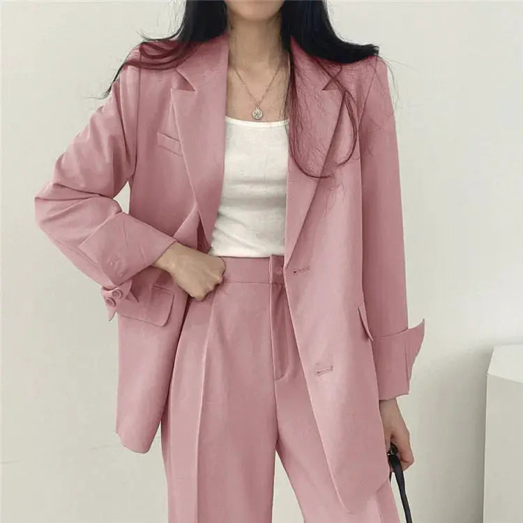 Pink women's 2-piece blazer and pants suit with long sleeves.