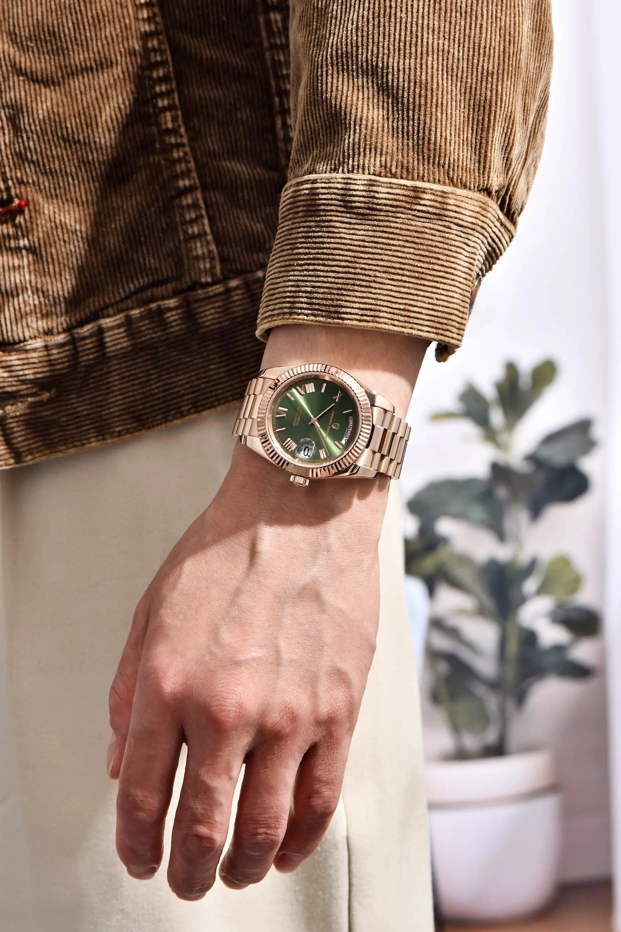 PAGANI DESIGN DD40 rose-gold men's automatic watch on wrist with green dial and stainless steel bracelet
