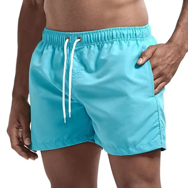 Men's turquoise swim shorts with white drawstring and side pockets