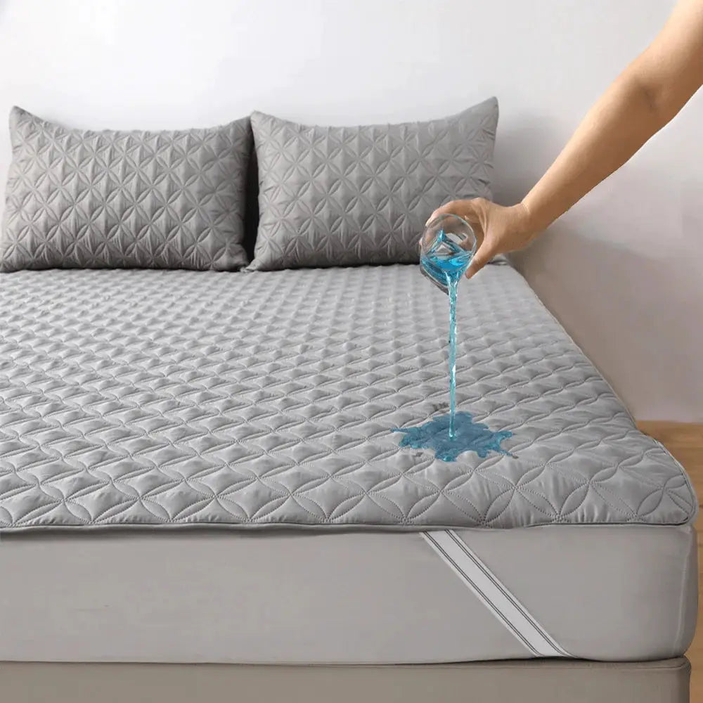 Gray quilted waterproof mattress protector; thickened, dustproof, breathable, allergy-resistant and noiseless.