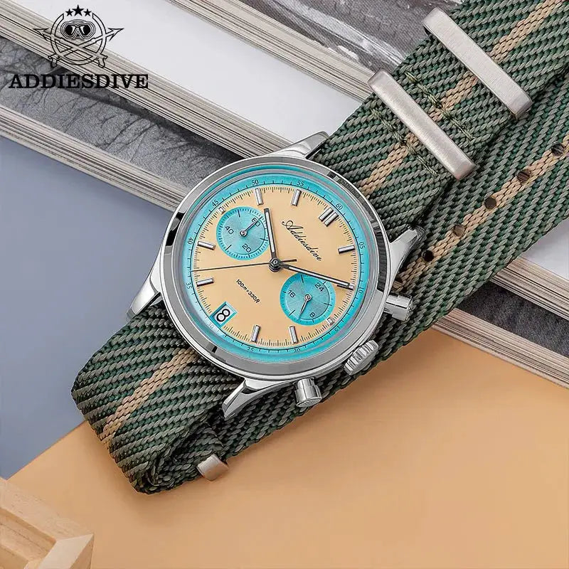 ADDIESDIVE men's chronograph wristwatch with turquoise subdials, beige dial, stainless steel case, green striped strap.