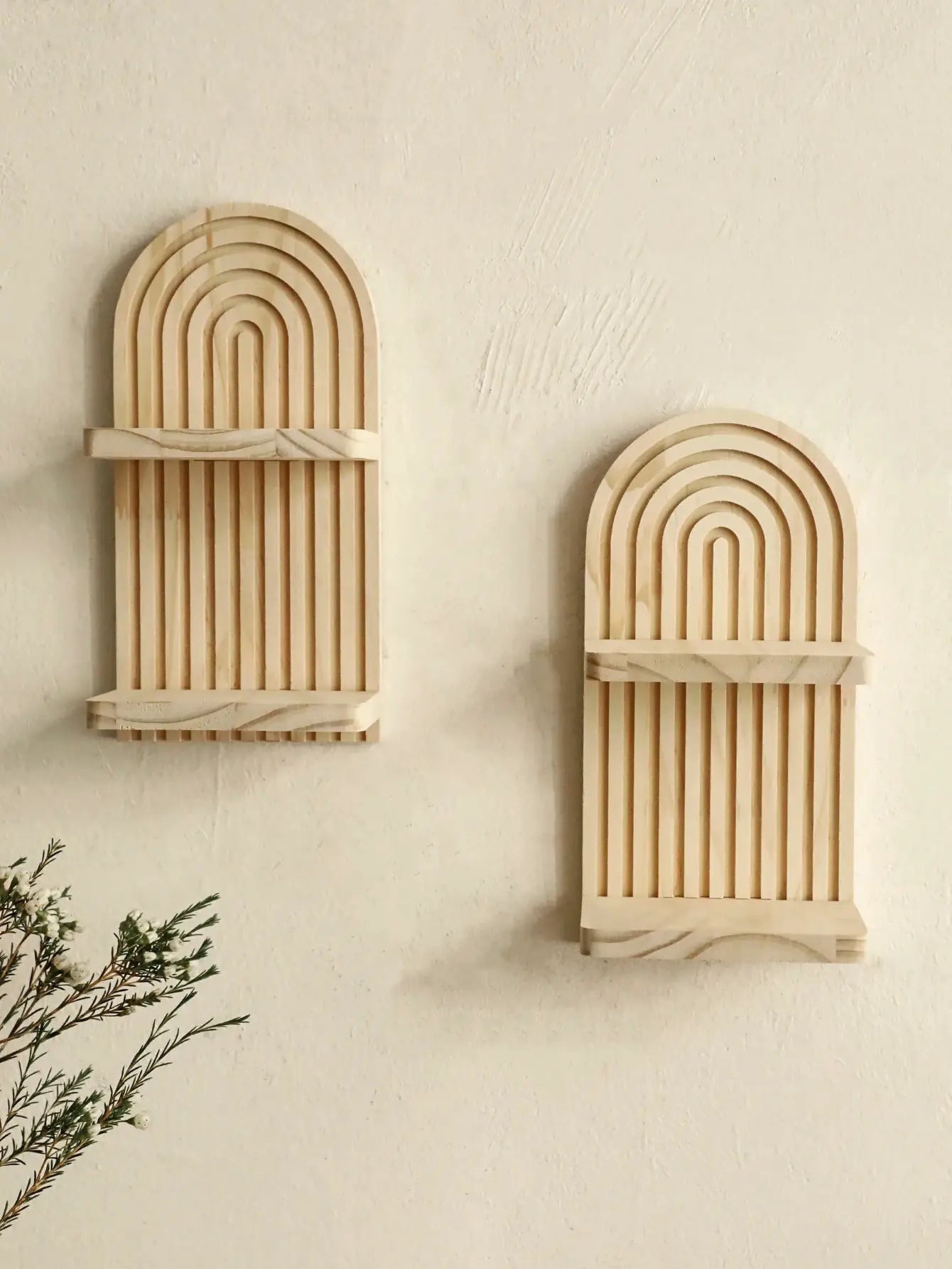 Two boho-style geometric wooden wall shelves with natural finish