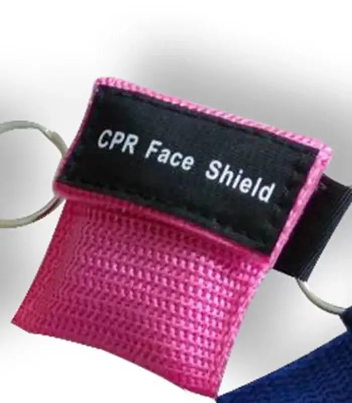 Keychain CPR face shield in pink fabric with black label, metal ring attachment.