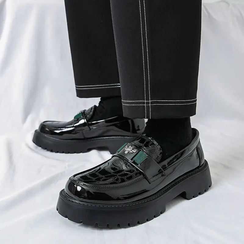 Men's black patent leather loafers with a thick platform sole and bee-embellished strap