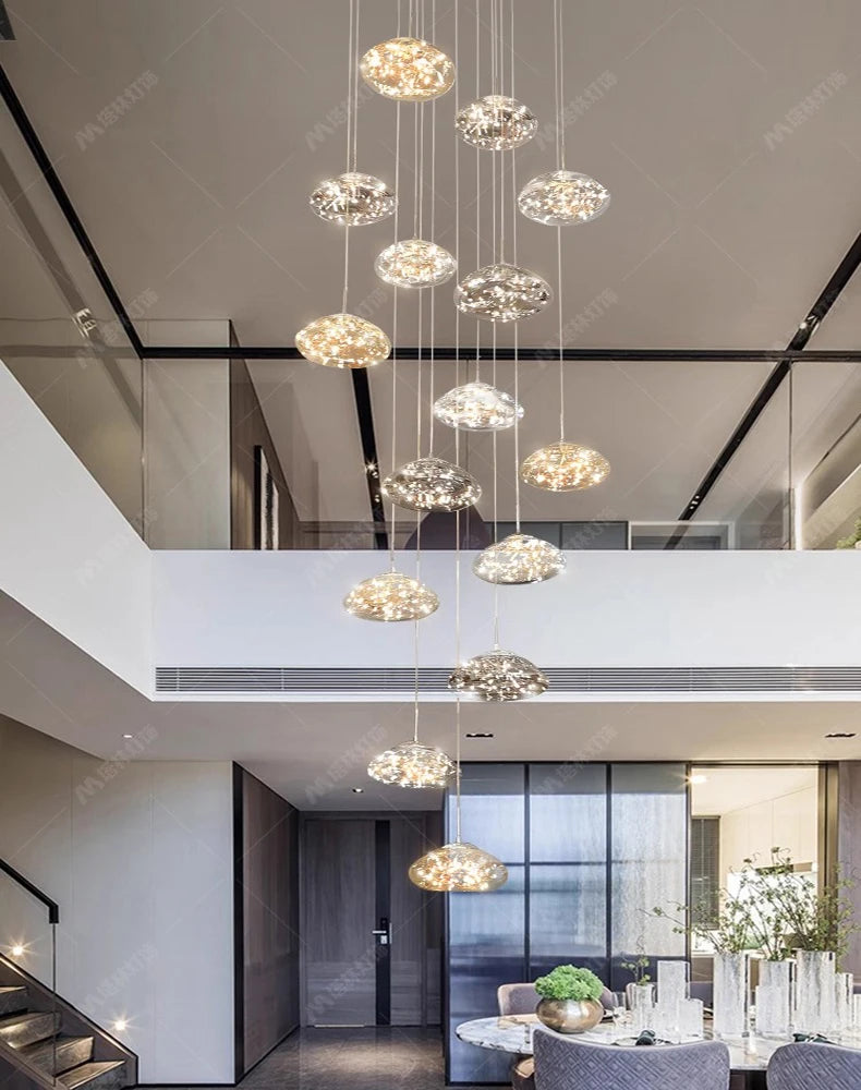 Simples Market modern pendant lights; clear glass orb chandeliers hanging over dining room table.