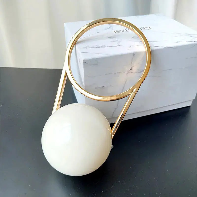 Luxury evening clutch with ball-handle acrylic, white orb and gold ring frame