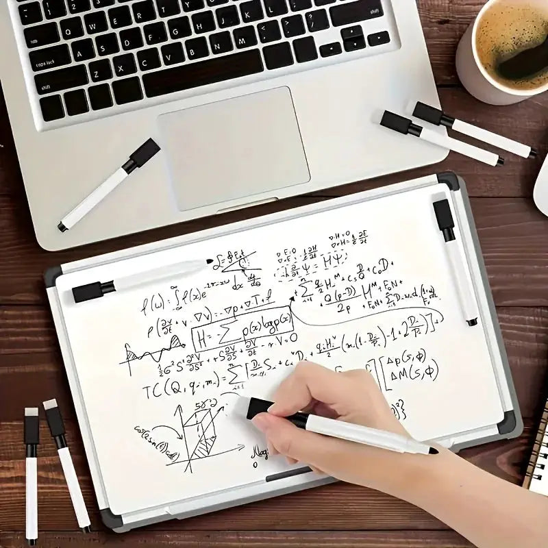 10-piece erasable whiteboard markers with built-in erasers, white bodies and black caps on a desk beside a laptop