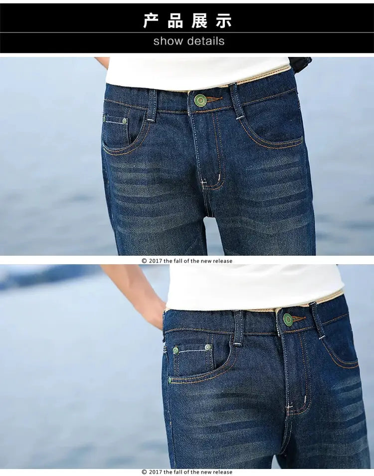 Men's blue denim jeans with whiskering and green rivets