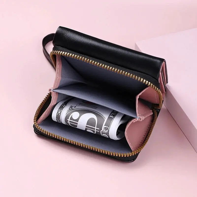 Women's PU leather tri-fold wallet with zipper, black exterior and pink interior, Simples Market, holding rolled bills