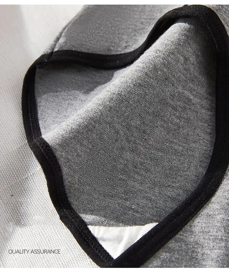 Plus-size cotton women's panties with black trim, grey fabric close-up.
