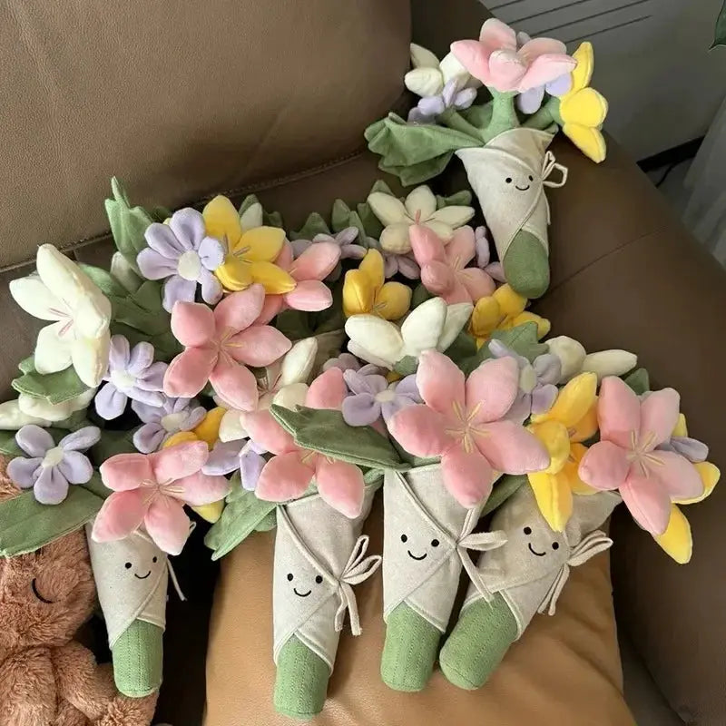 Simples Market holding flowers plush bouquet with pastel pink, purple and yellow petals and smiling wrapped stems