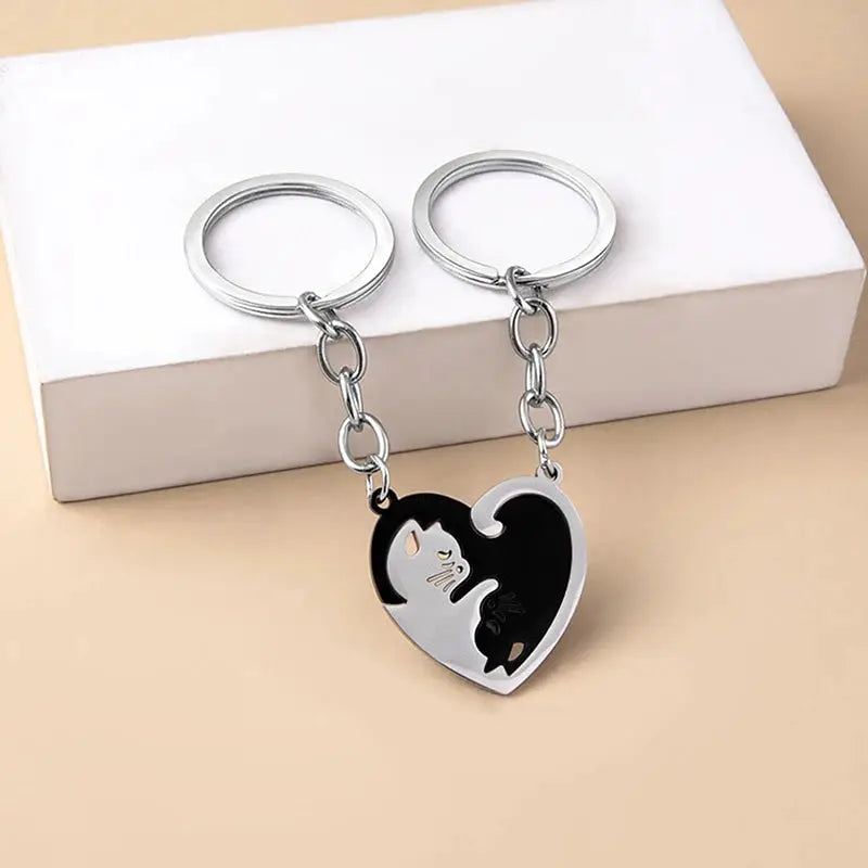 Cute Cat Hug keychain set of 2 with stainless steel heart pendants featuring black and white cats.