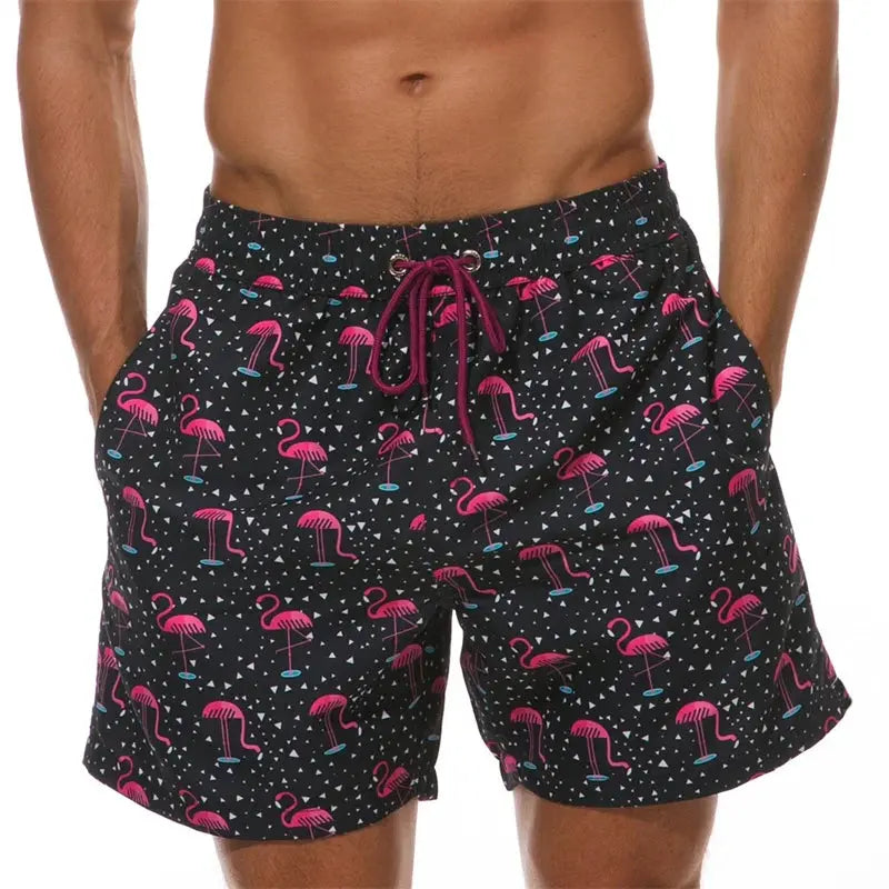 Men's Simples Market beach shorts with pink flamingo print on black, drawstring waist