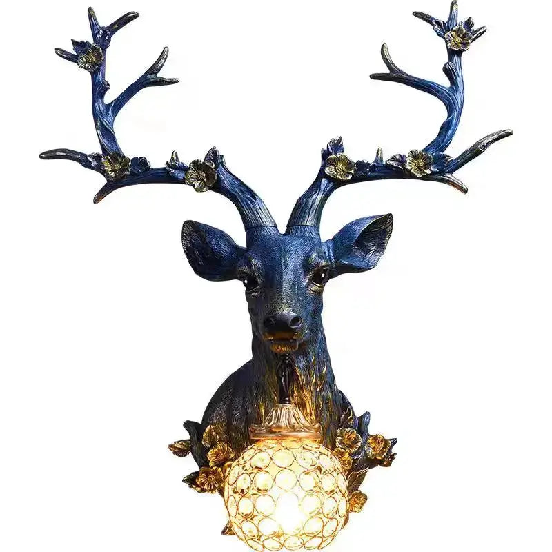 Lucky Deer wall lamp by Simples Market; blue resin deer head with floral antlers and glowing globe light.