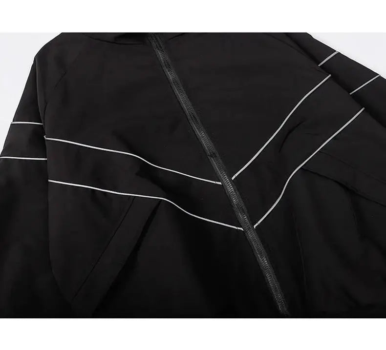 Black windbreaker varsity jacket with white piping and diagonal zipper.