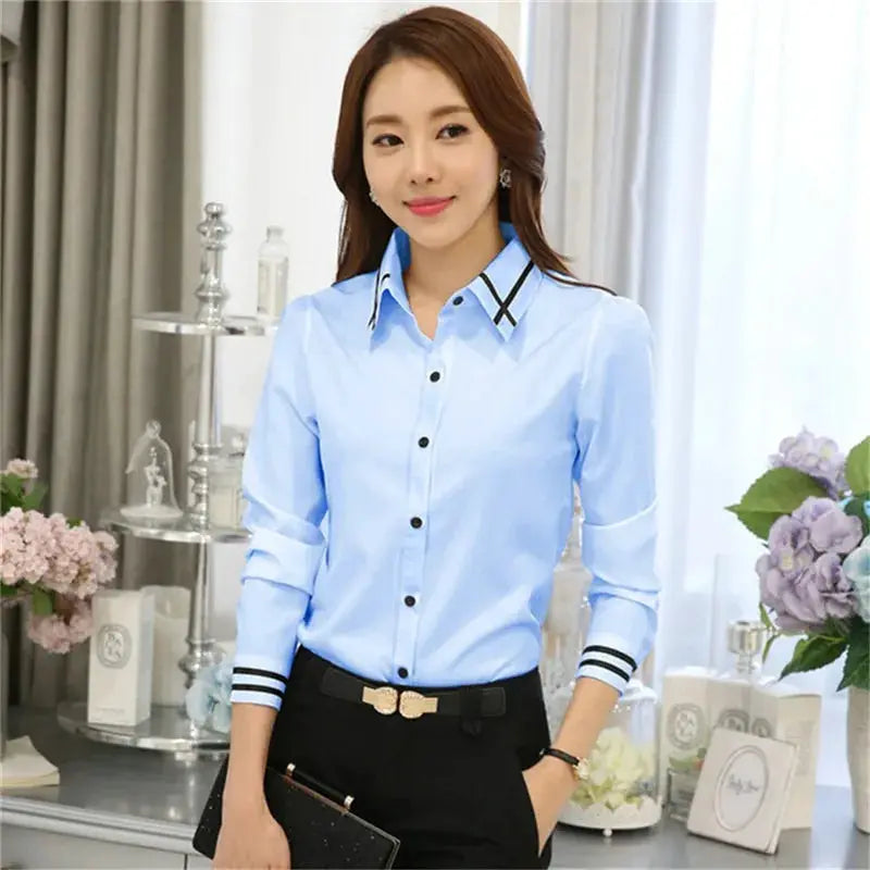 Blue long-sleeve women's shirt by Simples Market with black collar trim