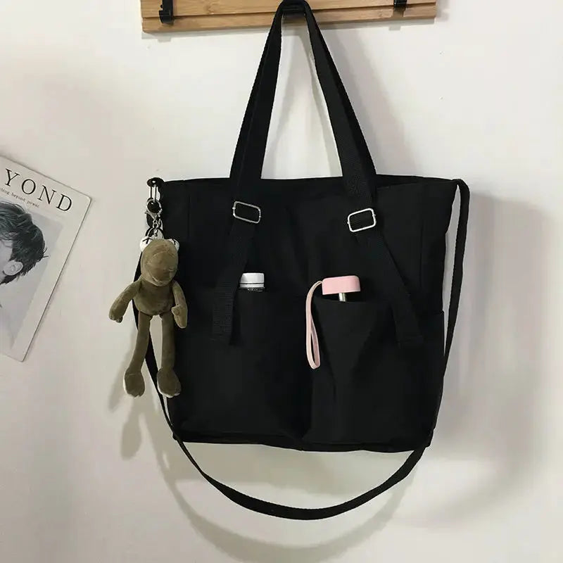 Waterproof Oxford large-capacity women's handbag by Simples Market with handles and adjustable crossbody strap.