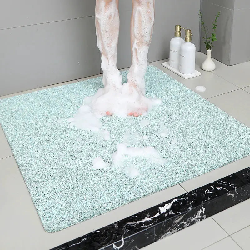 Non-slip hollow bath mat in grey speckled finish; foot massage shower mat for bathroom and hotel use.