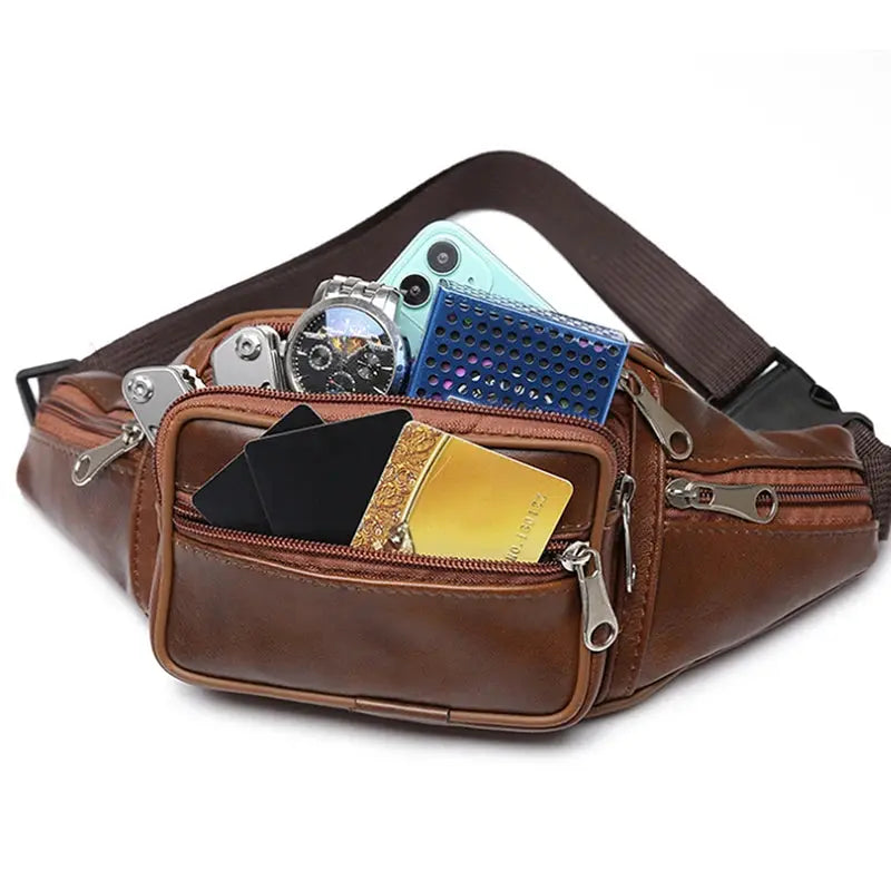 Brown PU leather men's waist bag with multiple zip pockets and adjustable strap, shown holding phone and cards.