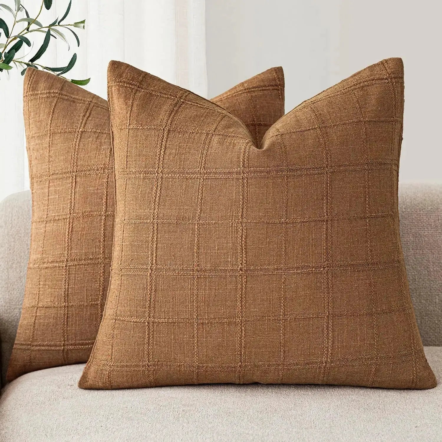 Brown square linen cushion cover with a stitched grid pattern, 40x40 cm.